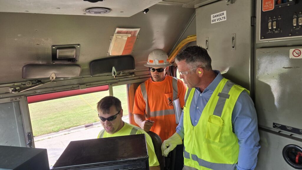 Rep. Tony Wied learns about short line operations from the cab of a FOXY locomotive.